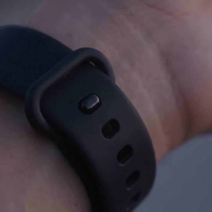 Close-up of the band’s pin-and-loop strap on a wrist